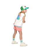 Girl model wearing the Happy Human Cap with the Debardeur Tennis and the CISS Logo Socks in White.