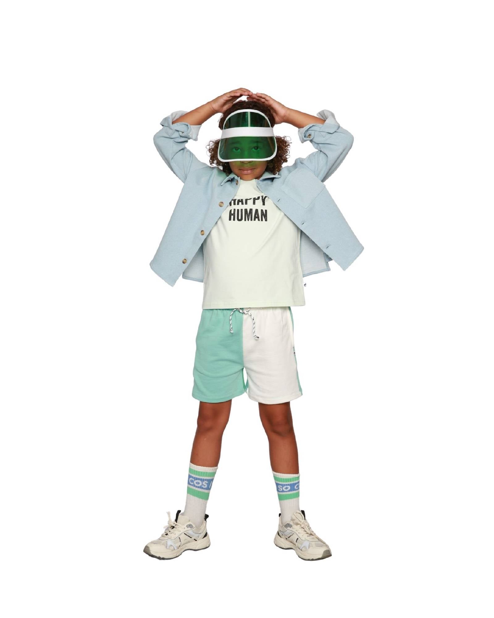 Boy model wearing Color Block Jog Shorts with T-Shirt Happy Human in Aqua Glaze and Logo Socks Ciss in White.