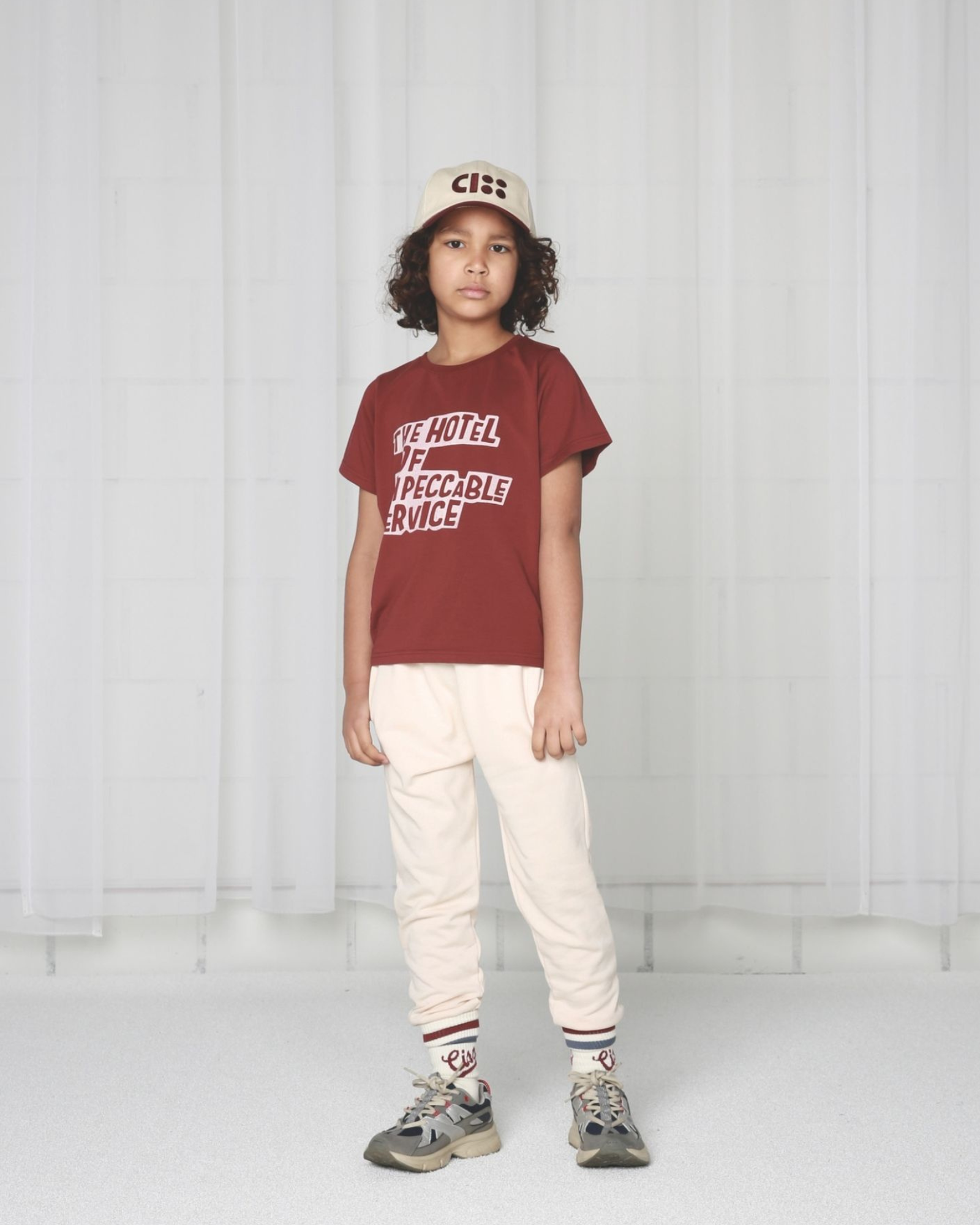 Boy model wearing the Jog Pants in Crystal Gray, an offwhite.