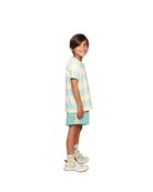 Boy model wearing the Socks Cos I Said So in Yellow Flower Anise on the Striped T-shirt Aqua Haze Anise and the Linen Shorts in Aqua Blue.