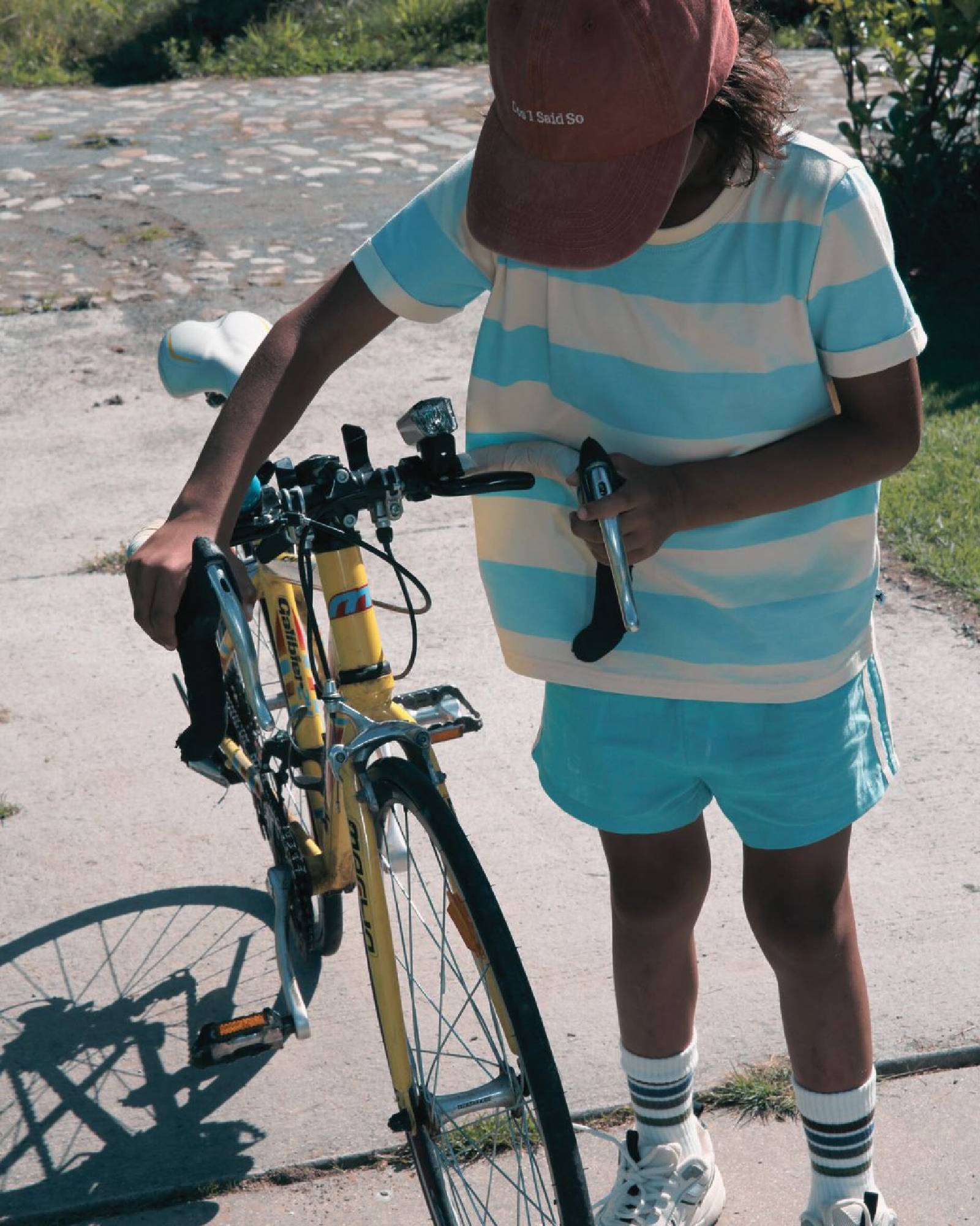 Boy model wearing the Linen Shorts in Turquoise with the Striped T-Shirt Aqua Haze Anise.