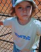 Boy model wearing the Vedette T-Shirt in White Jade, combined with the Colour Block Jog Shorts.