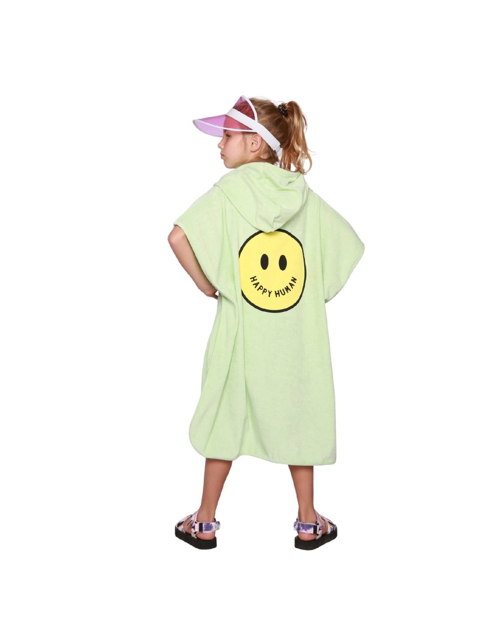 Girl model wearing the Towel Poncho in Paradise Green showing the Smiley on the back.