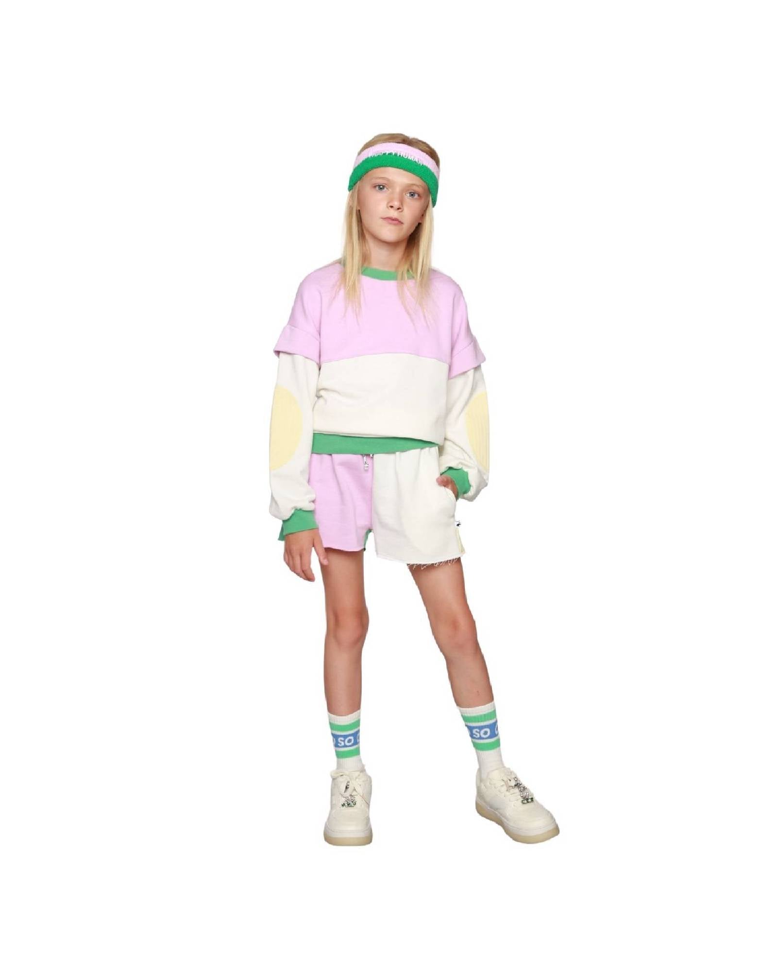 Girl model wearing the Happy Human Headband with the Color-Block Cut Off Jog Shorts and White Socks.