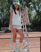 Girl model wearing the Tennis Debardeur with Cut Off Jog Shorts Color Block Pink and Cos I Said So Socks Anise Yellow.