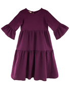 Girls Dress by LES VEDETTES in high quality muslin cotton. The dress with long sleeves is shown in aubergine.