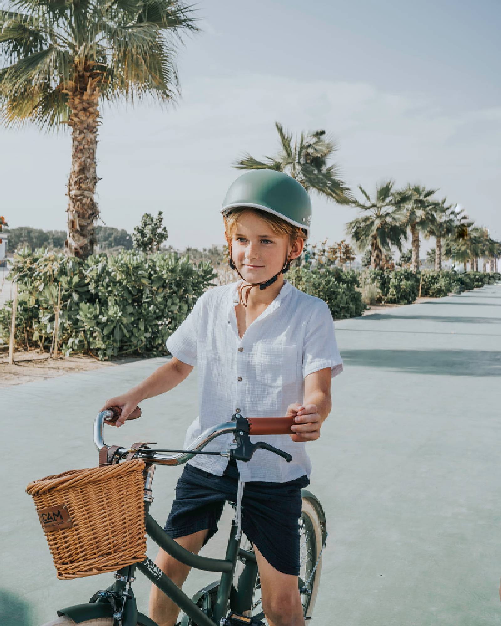 Boy model wearing the Raphael Shirt in White Muslin Cotton, combined with the Julian Shorts in Night Blue.